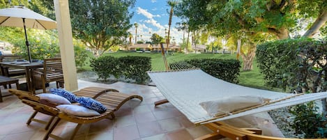 Enjoy the view of the golf course from the oversized hammock and lounge chairs