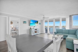 Living area with ceiling to floor sliding glass doors to private balcony