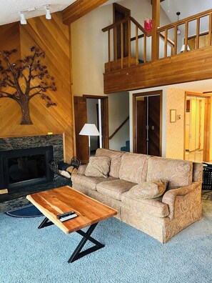 Large open living area with dining table and fireplace
