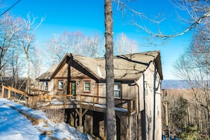 Charming cabin with mountain views, spacious deck, cozy ambiance, and serene setting.