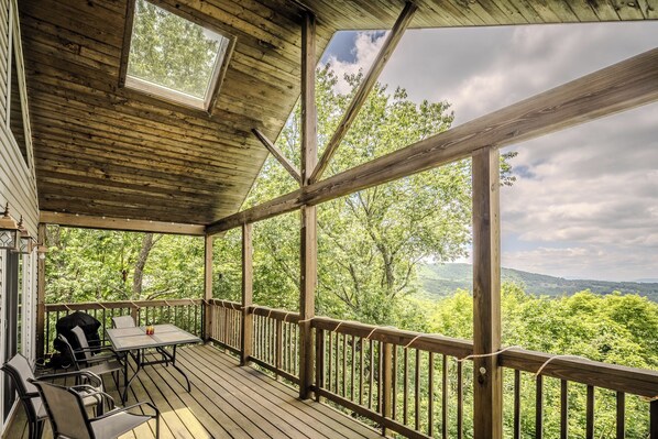 Spacious deck, hilltop views, wooden architecture, ample seating.