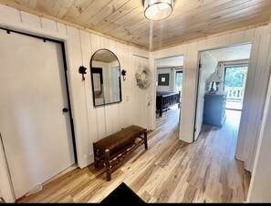 Rustic charm entry with sleek floors and cozy décor.