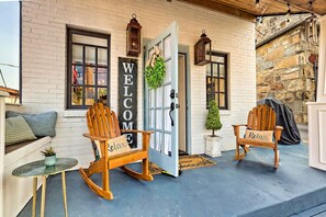 The cozy front porch with rocking chairs & bistro table - we are located just 1/2 block from Main Street.