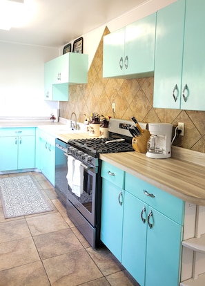 Kitchen with gas stove, dishwasher and all the tools needed to make a great meal