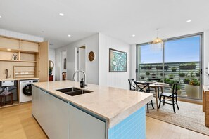 Kitchen and dining flow through to balcony