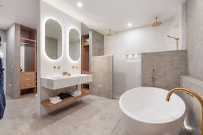 Large main ensuite with stone bath, king size double head shower and hotel robes