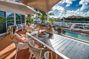Enjoy the spacious outdoor entertaining area overlooking the pool and canal.