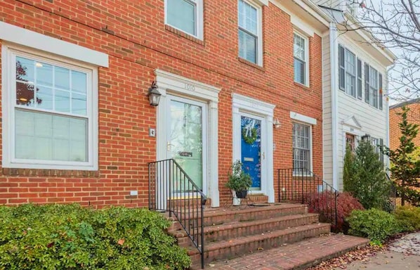 A classic and welcoming exterior with beautiful landscaping, perfect for a cozy and inviting stay.