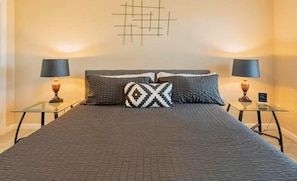 Sleep soundly in this chic bedroom with stylish decor, plush bedding, and soothing colors for a restful night's sleep.