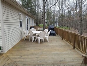 Outdoor dining on large wrap around deck with both gas and charcoal grills 