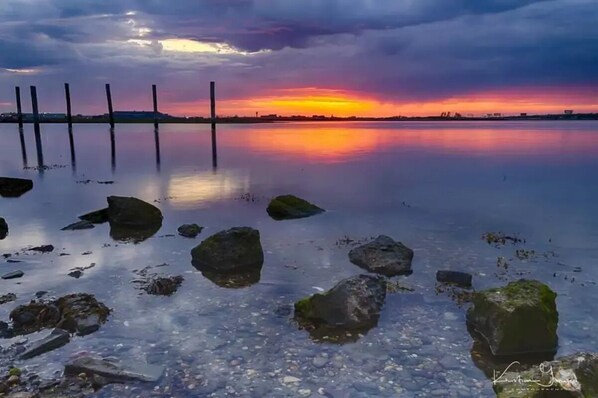 Grab your favorite drink & take a short walk to watch the sunset from the Bay.