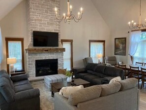 Living room with gas fireplace. (Pull Out queen bed in tan sofa)