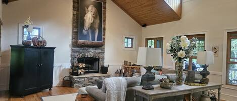 Open floor plan Living Room with wood burning fireplace.