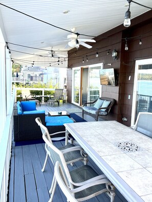 Upper level deck w/ 2 conversation areas, TV, and 2 dining areas