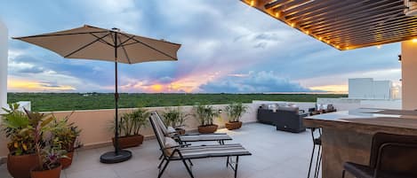 Enjoy sunsets from private rooftop patio