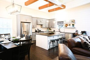 Large open concept kitchen with adjoining dining area and family room. 