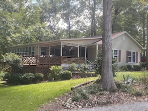 Back of house with covered porch and deck.