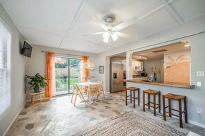 Dining area with table seating four and bar stool seating for three