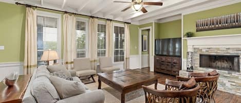 Living room with wood burning fireplace in the primary house.