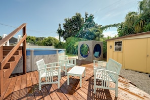 Big back deck with seating, dining, big pool, covered spa daybed and hot tub.