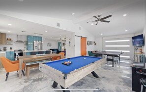 Game room with pool table, ping pong table, arcade table and TV