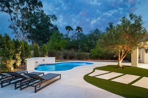 Resort style heated pool with water feature. 