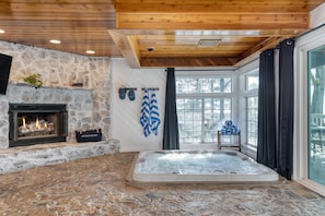Soak in the indoor hot tub right next to the fireplace.