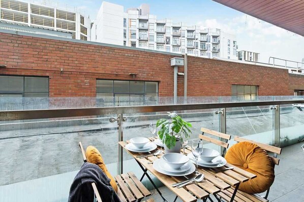 A large private balcony with a setting.