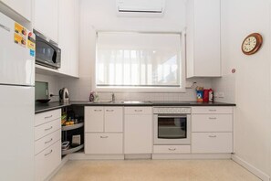 The renovated kitchen has plenty of appliances and utensils to cook anything at home, including an oven, microwave, coffee machine, dishwasher and stovetop. The reverse-cycle aircon will keep you comfy as well!