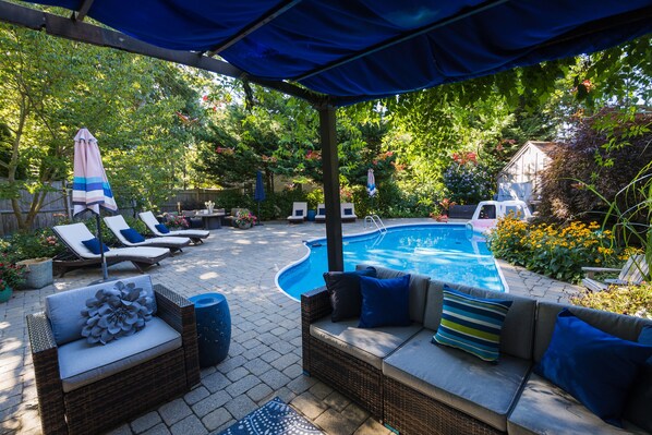 Private large outdoor area with in ground pool and covered pergola