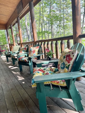 porch overlooks Lake, runs the length of the cabin,  also has a couch and rocker