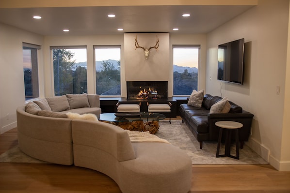 Stunning living room with 3-sided fireplace. Perfect spot to warm up post-ski.
