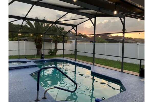 A peaceful pool setting during the evening sundown hours.