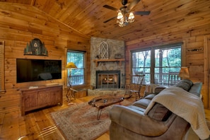 Inviting Living Room with Big Screen TV and Wood-Burning Fireplace