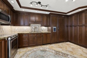 Kitchen, showing refrigerator, freezer, dishwasher, sink, and electric range.