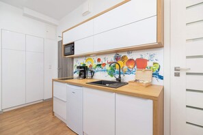 Another view of the kitchen area, showcasing its ample storage and functional design.
