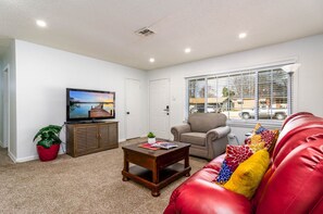 Family room: large TV with Roku, coffee table use as a desk/workstation.