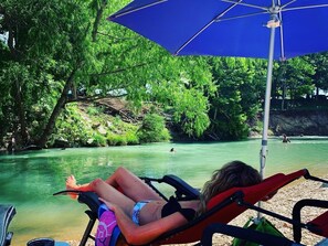 Guests get free use of chairs and umbrellas by the river