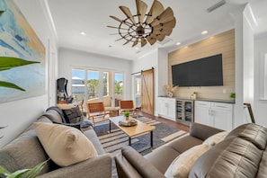 Enjoy a spacious second-floor living area complete with a wine fridge, a custom bunk room, and a game-filled arcade. Step out onto the covered balcony for a relaxing view of the backyard.