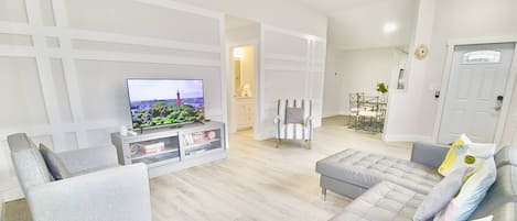 The spacious front room offers comfortable seating to relax and stream all your favorites on the large smart tv.