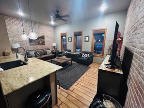 Enjoy the open living room and kitchen with 3 beautiful windows looking over F street. (1)