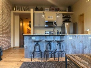 Enjoy the open living room and kitchen with 3 beautiful windows looking over F street. (2)