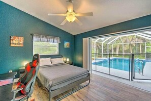 Queen bed with the best pool view and dedicated workspace with gaming chair.
