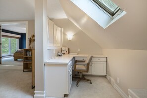 Workspace area in Bedroom 1 with desk and work chair.