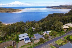 The house looks out at Smiths Lake and Sandbar as well as the Pacific ocean.