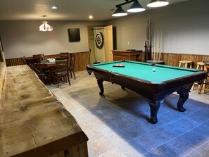 Game room with pool table, roulette table, poker table, and numerous board games