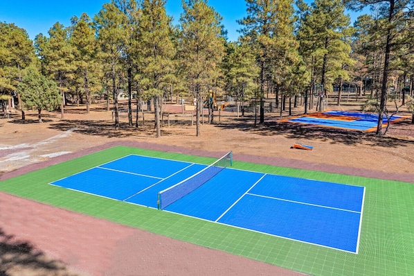 [Backyard Amenities] Pickleball court with sport court covering, basketball court, and playground