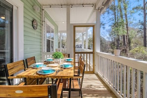 Flowing out from the indoor dining area is alfresco dining on the screened veranda.