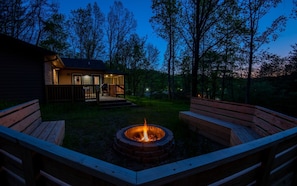 Gather around the firepit with built-in seating for cozy nights at Dolly's Cabin