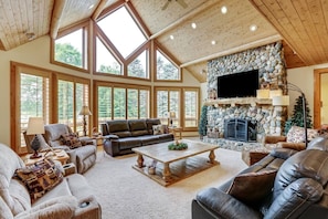 The Main Level living Room with Incredible Views of the lake and golf course. The river rock fireplaces are amazing! (Electric fireplace inserts)